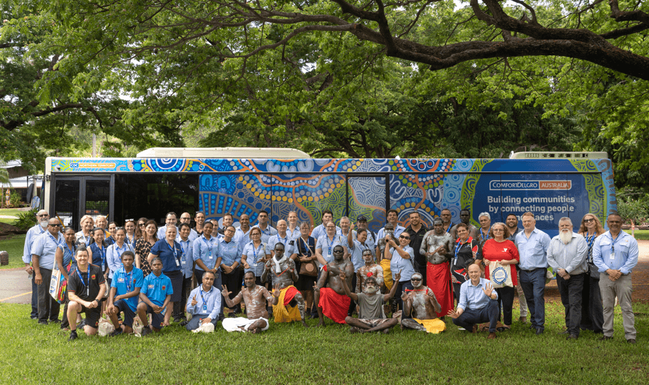 Picture of bus with people standing in front